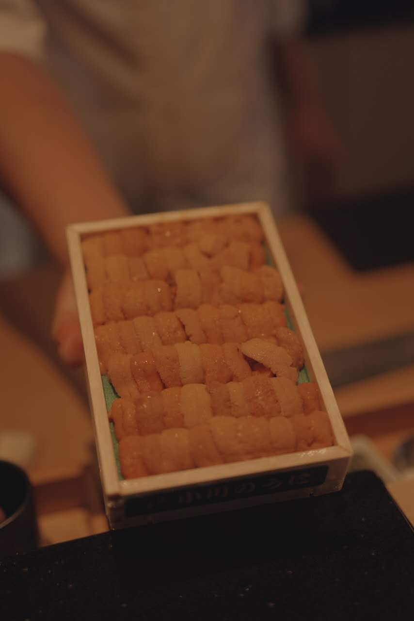 Fresh uni box opened at the counter during omakase