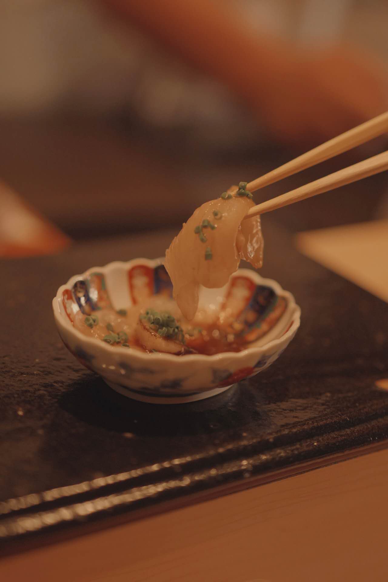 Sashimi with chopsticks and ponzu